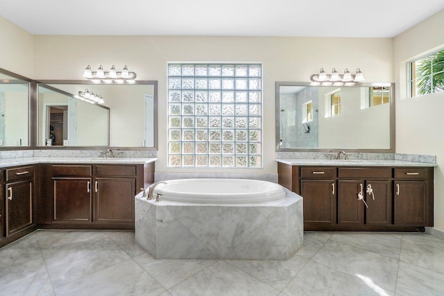 8440 Serena Creek Ave, Boynton Beach, FL 33473 - full bath with two vanities, a garden tub, and tile patterned flooring