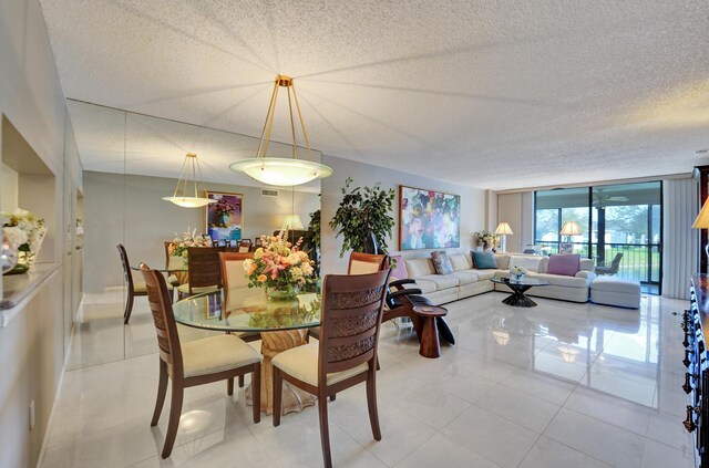 15355 Lakes Of Delray Blvd Unit 211, Delray Beach, FL 33484 - dining space with light tile patterned floors, a textured ceiling, and expansive windows