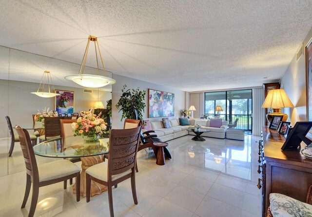 15355 Lakes Of Delray Blvd Unit 211, Delray Beach, FL 33484 - dining space featuring a textured ceiling, light tile patterned floors, and expansive windows