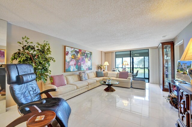 15355 Lakes Of Delray Blvd Unit 211, Delray Beach, FL 33484 - tiled living room with a textured ceiling and floor to ceiling windows