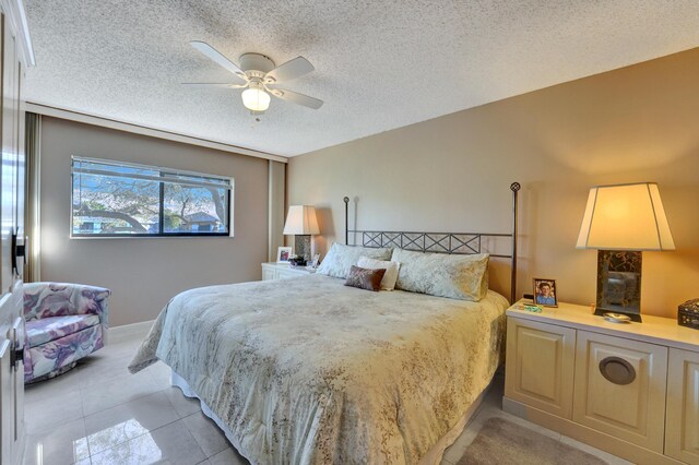 15355 Lakes Of Delray Blvd Unit 211, Delray Beach, FL 33484 - bedroom with a textured ceiling, light tile patterned floors, and ceiling fan
