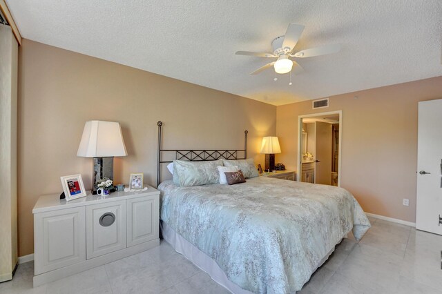 15355 Lakes Of Delray Blvd Unit 211, Delray Beach, FL 33484 - bedroom with a textured ceiling, baseboards, and a ceiling fan