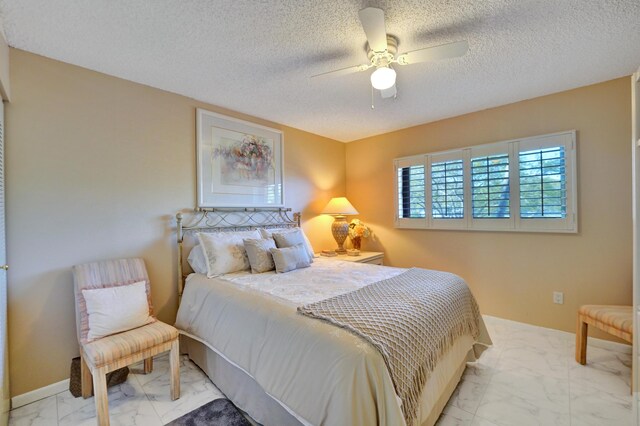 15355 Lakes Of Delray Blvd Unit 211, Delray Beach, FL 33484 - bedroom featuring marble finish flooring, a textured ceiling, and ceiling fan