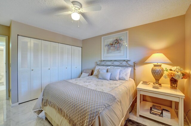 15355 Lakes Of Delray Blvd Unit 211, Delray Beach, FL 33484 - bedroom with a closet, marble look tile flooring, a textured ceiling, and ceiling fan