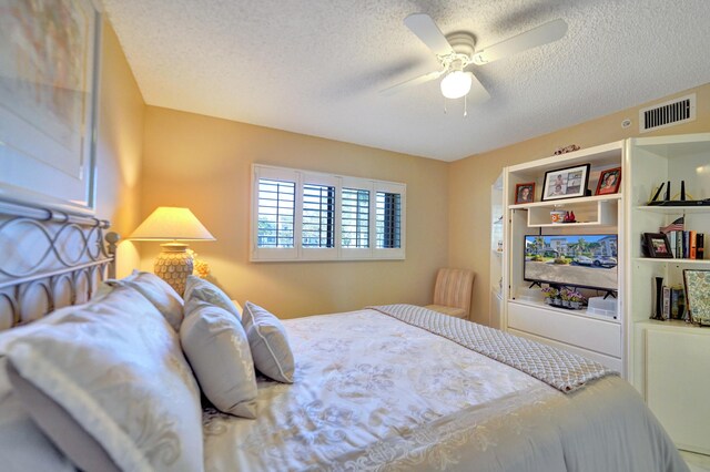 15355 Lakes Of Delray Blvd Unit 211, Delray Beach, FL 33484 - bedroom with a textured ceiling and ceiling fan