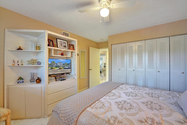 15355 Lakes Of Delray Blvd Unit 211, Delray Beach, FL 33484 - bedroom featuring a textured ceiling, a closet, light marble finish flooring, and a ceiling fan