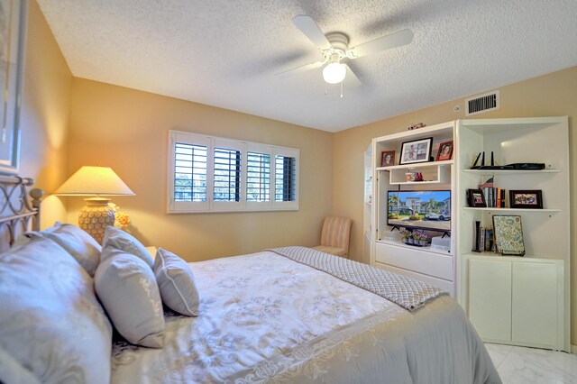 15355 Lakes Of Delray Blvd Unit 211, Delray Beach, FL 33484 - bedroom with a textured ceiling, light marble finish flooring, and a ceiling fan