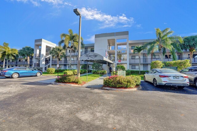 15355 Lakes Of Delray Blvd Unit 211, Delray Beach, FL 33484 - view of property with uncovered parking