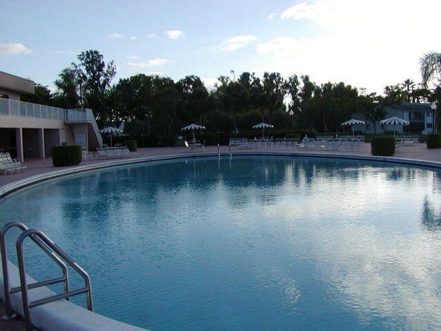 15355 Lakes Of Delray Blvd Unit 211, Delray Beach, FL 33484 - community pool featuring a patio