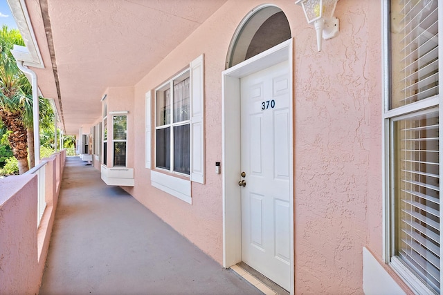 18081 SE Country Club Dr Unit 370, Tequesta, FL 33469 - view of exterior entry with stucco siding and covered porch