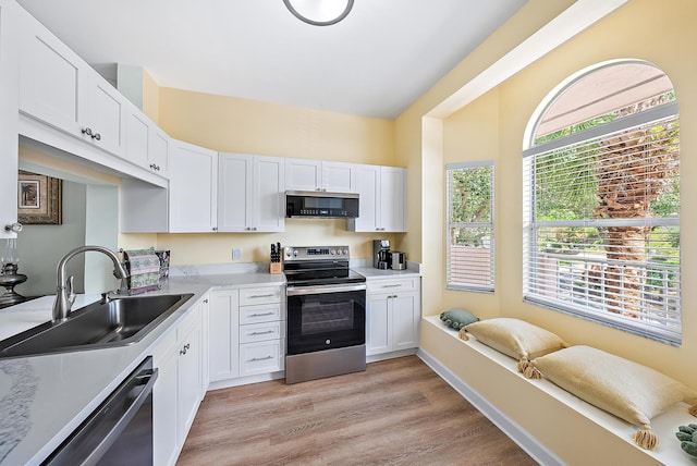 18081 SE Country Club Dr Unit 370, Tequesta, FL 33469 - kitchen featuring appliances with stainless steel finishes, a sink, white cabinets, light countertops, and light wood-type flooring