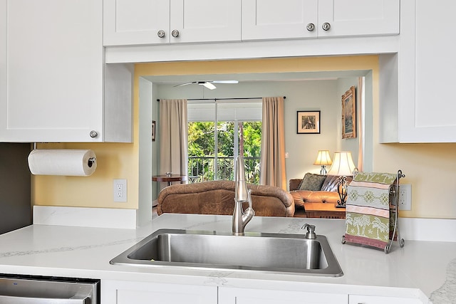 18081 SE Country Club Dr Unit 370, Tequesta, FL 33469 - kitchen with a sink, stainless steel dishwasher, white cabinetry, ceiling fan, and light stone countertops