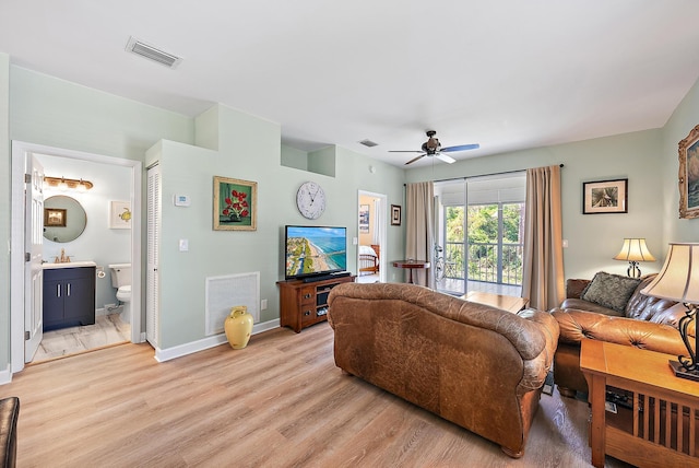18081 SE Country Club Dr Unit 370, Tequesta, FL 33469 - living area with light wood finished floors, a ceiling fan, and baseboards