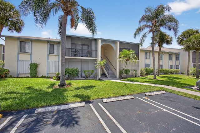 1104 Green Pine Blvd Unit D2, West Palm Beach, FL 33409 - view of property with uncovered parking and stairway