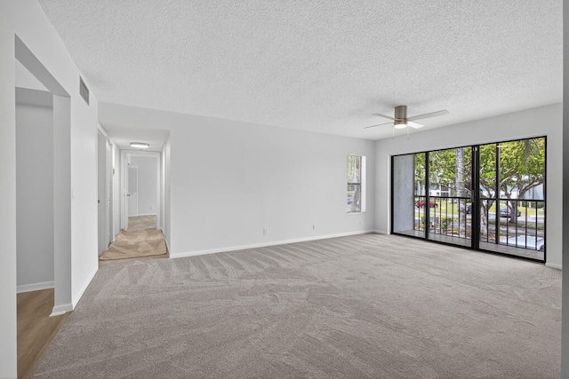 1104 Green Pine Blvd Unit D2, West Palm Beach, FL 33409 - carpeted empty room featuring a ceiling fan and a textured ceiling