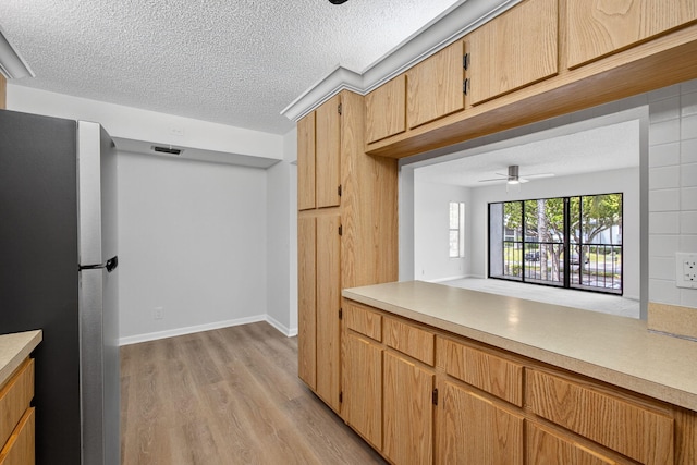 1104 Green Pine Blvd Unit D2, West Palm Beach, FL 33409 - kitchen with freestanding refrigerator, light wood-style flooring, light countertops, and a textured ceiling