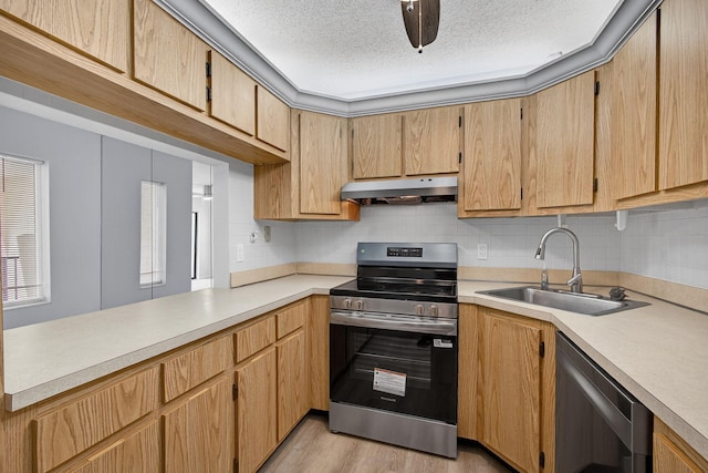 1104 Green Pine Blvd Unit D2, West Palm Beach, FL 33409 - kitchen featuring appliances with stainless steel finishes, under cabinet range hood, light countertops, backsplash, and a textured ceiling