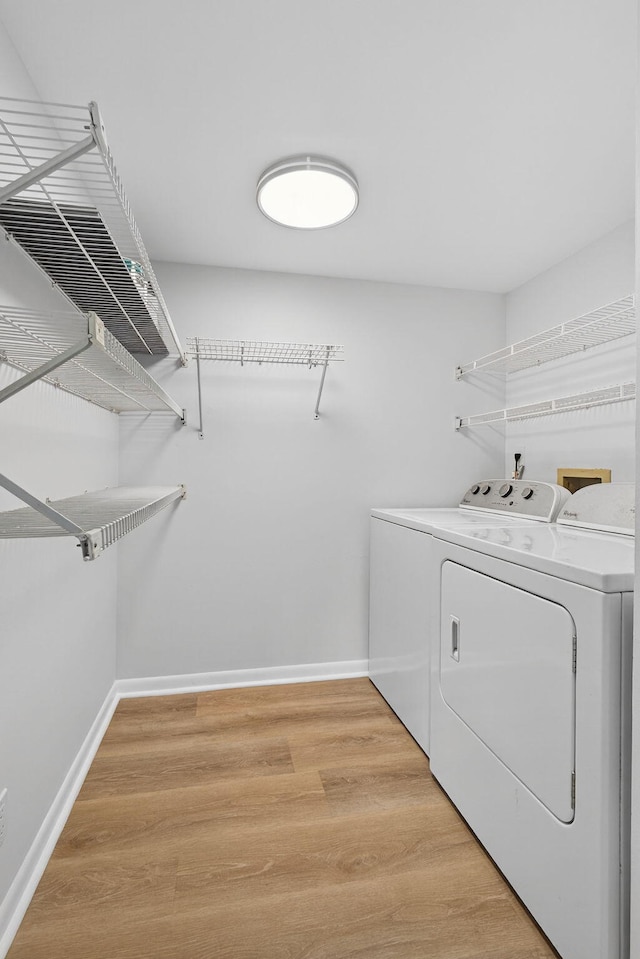 1104 Green Pine Blvd Unit D2, West Palm Beach, FL 33409 - laundry room with washer and clothes dryer and light wood finished floors