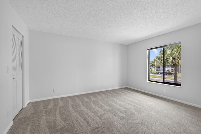 1104 Green Pine Blvd Unit D2, West Palm Beach, FL 33409 - unfurnished bedroom with carpet floors and a textured ceiling