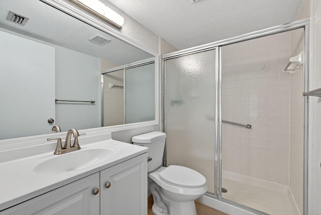 1104 Green Pine Blvd Unit D2, West Palm Beach, FL 33409 - bathroom featuring a stall shower, vanity, and a textured ceiling