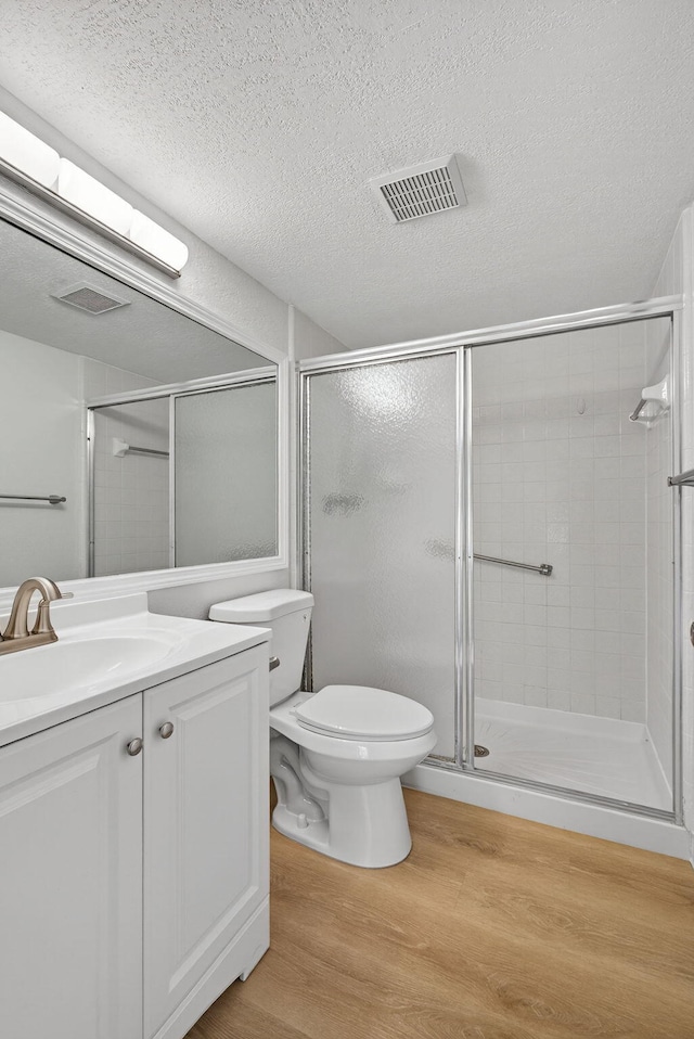 1104 Green Pine Blvd Unit D2, West Palm Beach, FL 33409 - bathroom with wood finished floors, vanity, a stall shower, and a textured ceiling