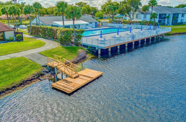 1104 Green Pine Blvd Unit D2, West Palm Beach, FL 33409 - dock with a community pool, a water view, a residential view, and a yard