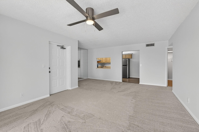 1104 Green Pine Blvd Unit D2, West Palm Beach, FL 33409 - unfurnished living room with a textured ceiling, carpet floors, and ceiling fan