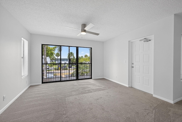 1104 Green Pine Blvd Unit D2, West Palm Beach, FL 33409 - spare room with carpet floors, ceiling fan, and a textured ceiling