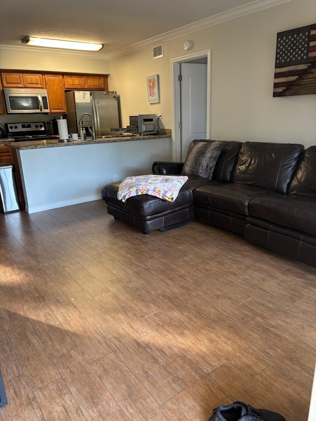 living room featuring crown molding and wood finished floors