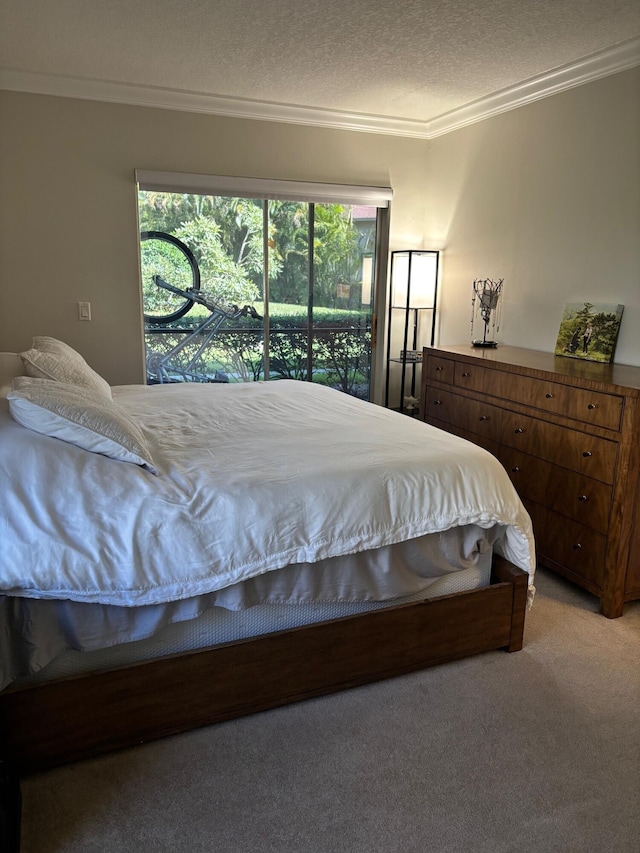 bedroom featuring ornamental molding, light colored carpet, and a textured ceiling