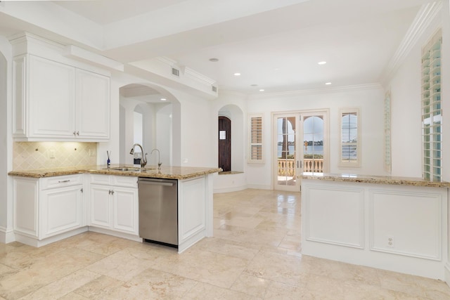 3309 S Flagler Dr, West Palm Beach, FL 33405 - kitchen with stainless steel dishwasher, arched walkways, a peninsula, a sink, and light stone counters