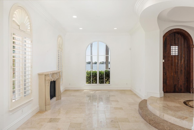 3309 S Flagler Dr, West Palm Beach, FL 33405 - foyer entrance with baseboards, light marble finish flooring, recessed lighting, a fireplace, and crown molding