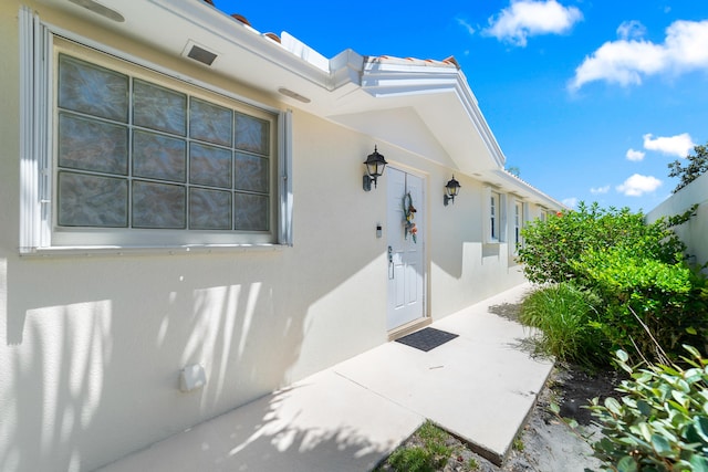 1056 SW Balmoral Trce, Stuart, FL 34997 - doorway to property featuring stucco siding