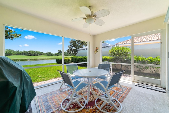 1056 SW Balmoral Trce, Stuart, FL 34997 - sunroom with a water view, outdoor dining area, and a ceiling fan