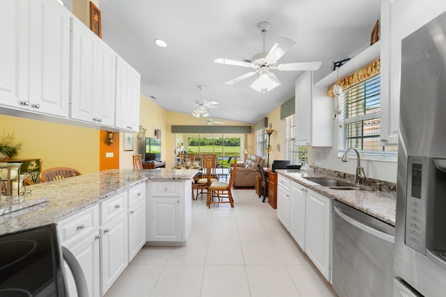 1056 SW Balmoral Trce, Stuart, FL 34997 - kitchen featuring stainless steel appliances, a sink, ceiling fan, lofted ceiling, and healthy amount of natural light
