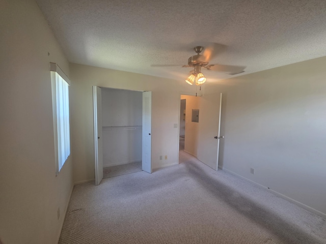 7690 Tahiti Ln Unit 202, Lake Worth, FL 33467 - unfurnished bedroom with light carpet, a closet, a textured ceiling, ceiling fan, and baseboards
