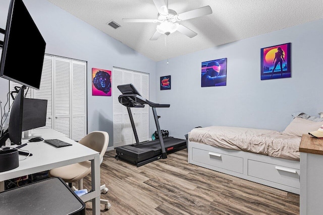 5350 Casa Real Dr, Delray Beach, FL 33484 - bedroom with vaulted ceiling, a textured ceiling, wood finished floors, a desk, and a ceiling fan