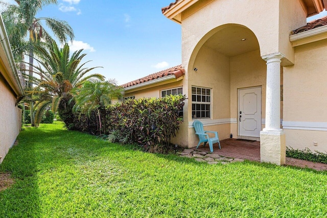 5350 Casa Real Dr, Delray Beach, FL 33484 - view of exterior entry featuring a lawn and stucco siding