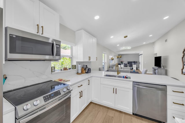 8076 Sweetbriar Way, Boca Raton, FL 33496 - kitchen featuring stainless steel appliances, a sink, light wood-type flooring, open floor plan, and white cabinetry