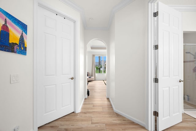 225 NW Magnolia Lakes Blvd, Port Saint Lucie, FL 34986 - corridor with arched walkways, ornamental molding, light wood-style flooring, and baseboards