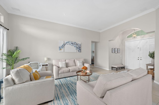 225 NW Magnolia Lakes Blvd, Port Saint Lucie, FL 34986 - living room featuring arched walkways, crown molding, light tile patterned floors, and baseboards