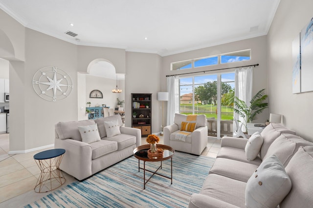 225 NW Magnolia Lakes Blvd, Port Saint Lucie, FL 34986 - living room with light tile patterned floors, arched walkways, crown molding, a high ceiling, and baseboards