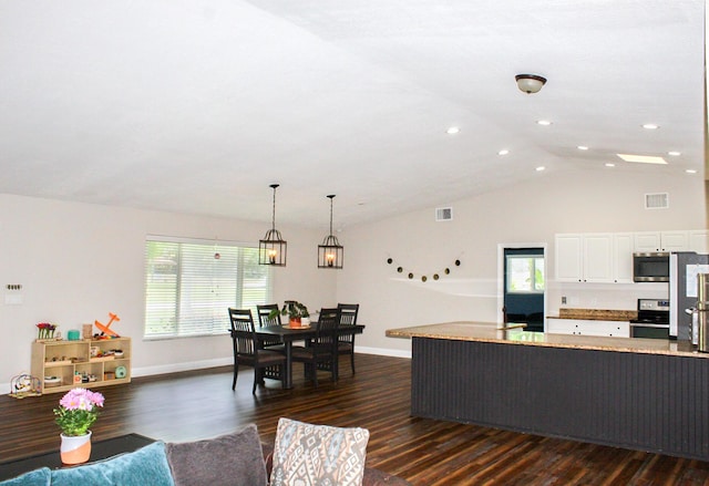 2182 SE Bersell Rd, Port Saint Lucie, FL 34952 - living room featuring dark wood finished floors, baseboards, plenty of natural light, recessed lighting, and high vaulted ceiling