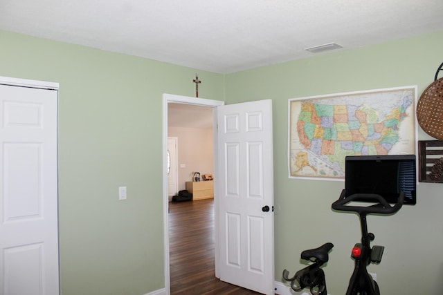 2182 SE Bersell Rd, Port Saint Lucie, FL 34952 - exercise area featuring dark wood-style flooring and baseboards
