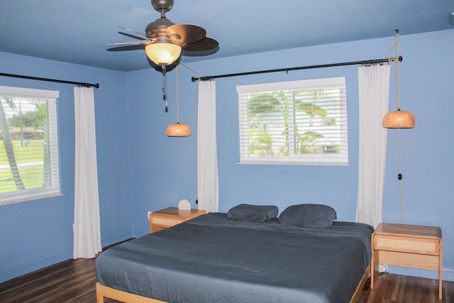 2182 SE Bersell Rd, Port Saint Lucie, FL 34952 - bedroom featuring dark wood-style floors, multiple windows, and baseboards