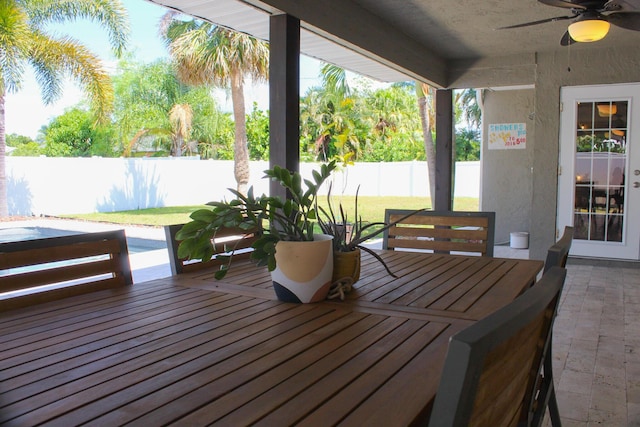 2182 SE Bersell Rd, Port Saint Lucie, FL 34952 - wooden terrace with a ceiling fan, a patio, and outdoor dining area