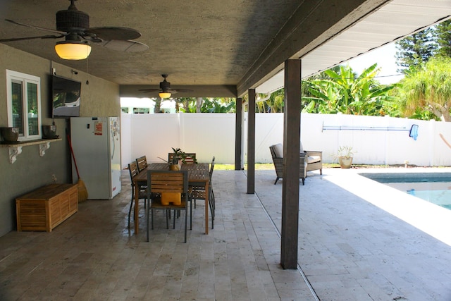 2182 SE Bersell Rd, Port Saint Lucie, FL 34952 - fenced backyard featuring a patio, a ceiling fan, and outdoor dining area