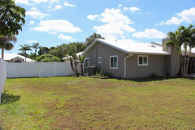 2182 SE Bersell Rd, Port Saint Lucie, FL 34952 - view of yard featuring central AC unit and a gate