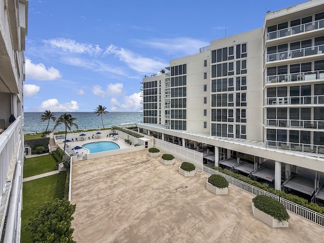 3570 S Ocean Blvd Unit 506, South Palm Beach, FL 33480 - view of swimming pool with a water view, a patio, and a hot tub