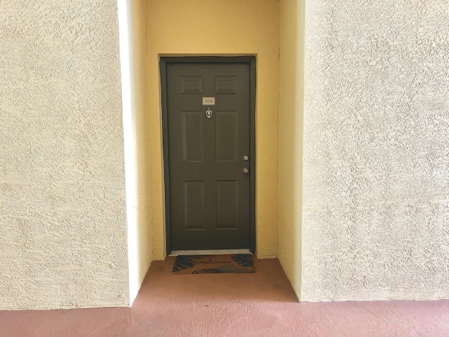 6511 Emerald Dunes Dr Unit 308, West Palm Beach, FL 33411 - view of exterior entry featuring stucco siding